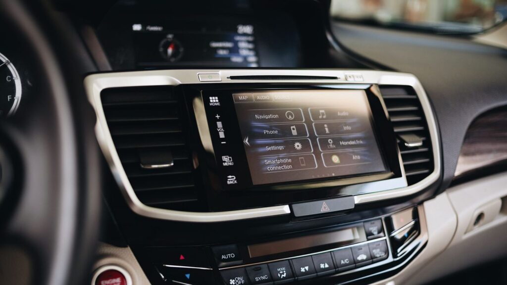 The technician checks the car navigation system